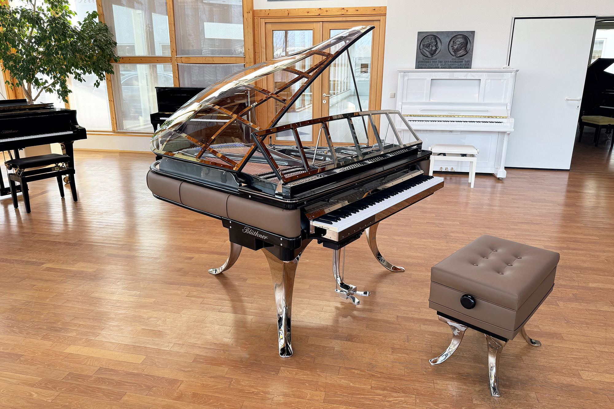 Original Blüthner PH Piano 150cm with brown leather, chrome metal fittings and a black iron frame.
