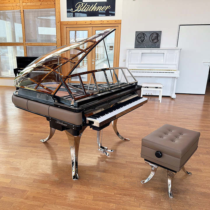 Original Blüthner PH Piano 150cm with brown leather, chrome metal fittings and a black iron frame.