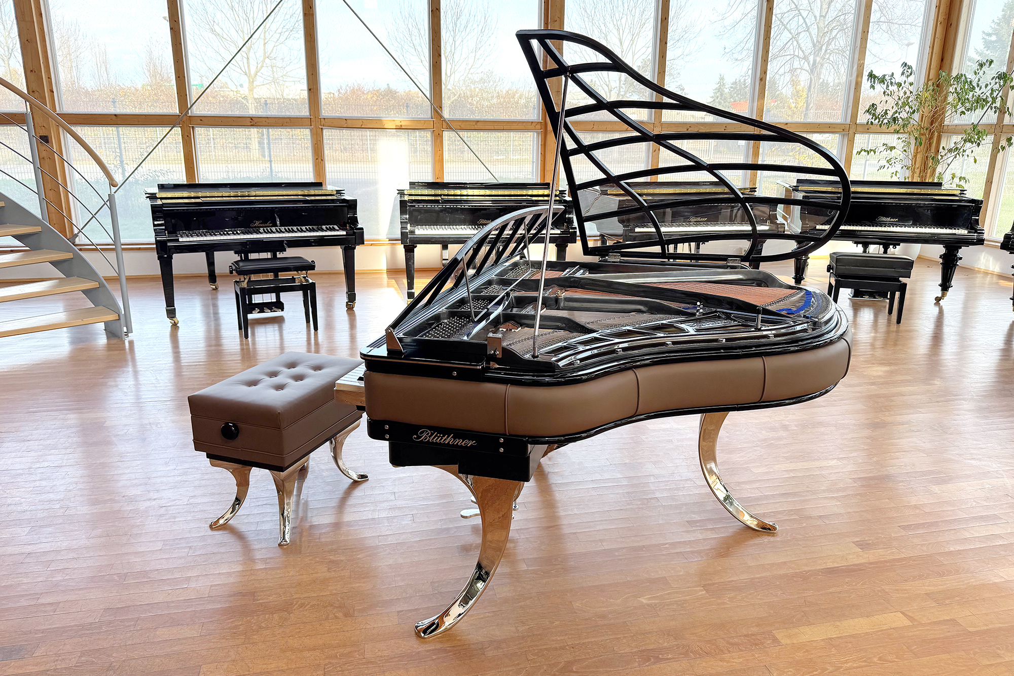 Original Blüthner PH Piano 150cm with brown leather, chrome metal fittings and a black iron frame.