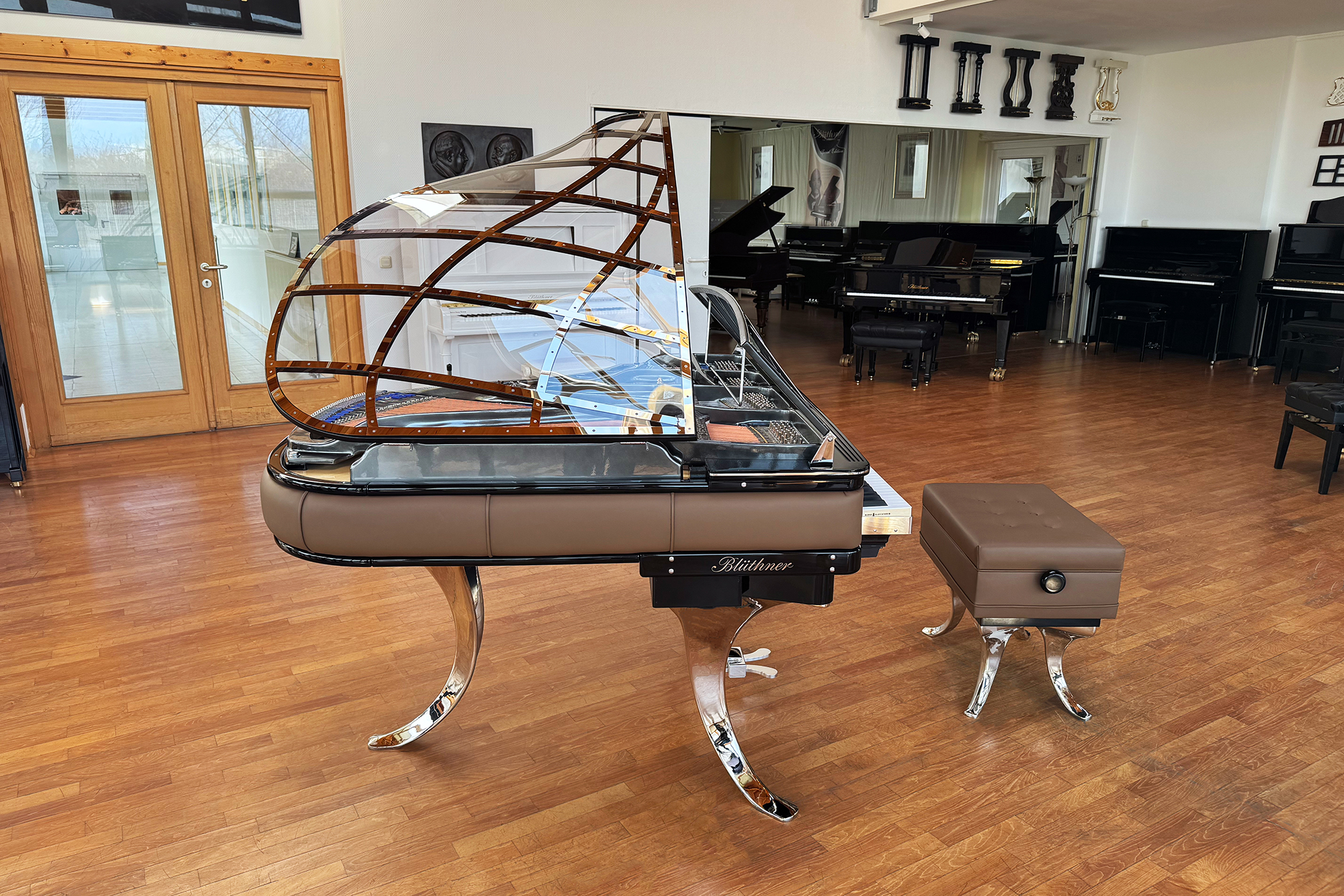 Original Blüthner PH Piano 150cm with brown leather, chrome metal fittings and a black iron frame.