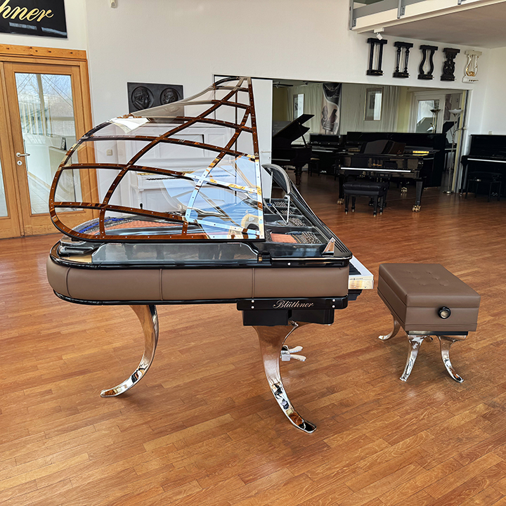 Original Blüthner PH Piano 150cm with brown leather, chrome metal fittings and a black iron frame.